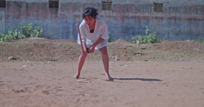 Traditional Indian Game Gilli Danda Played by Village Girl