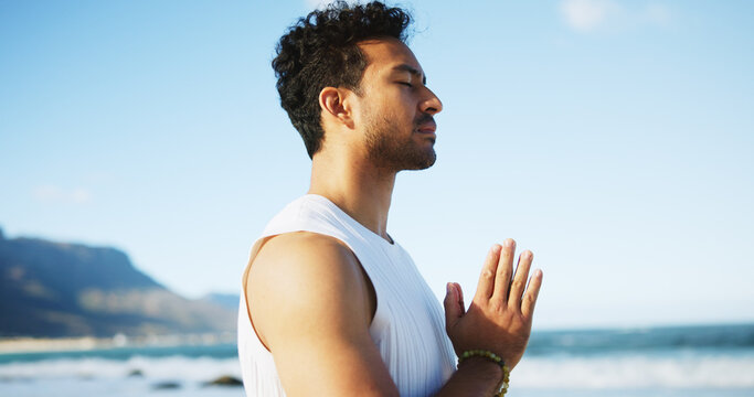 Zen, man and yoga at ocean with meditation, prayer hands and peaceful moment for spiritual healing. Calm, person and mindfulness at beach with mantra, namaste pose and chakra alignment for wellness.