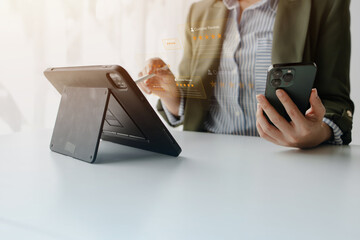 A business professional checks customer reviews on a smartphone beside a tablet, symbolizing online feedback, digital trust, service evaluation, and data driven decisions in modern business.