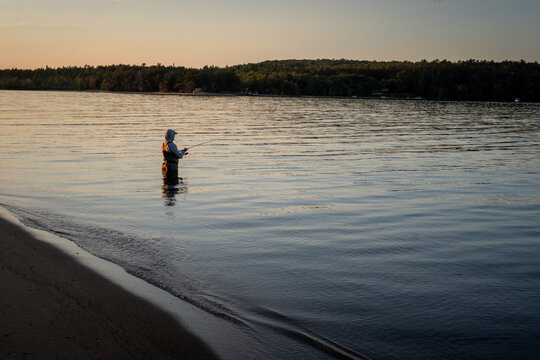 Man Fishing at Sunset in Munising Bay, Lake Superior, Upper Peninsula of Michigan