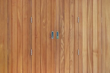 Wood panels folding door with handles and keyhole background
