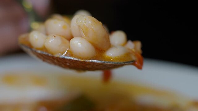 Soup is served with white beans and vegetables in a bowl