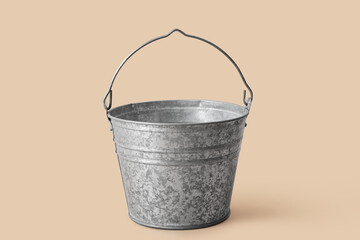 Galvanized metal bucket on beige background