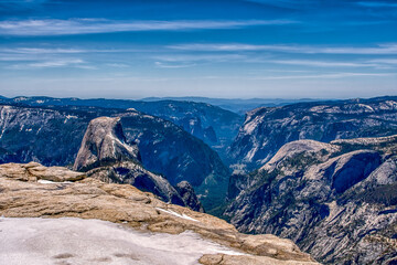 The mountains are covered in snow and the sky is blue. The mountains are very tall and the snow is...