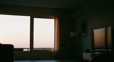 Dimly Lit Modern Living Room with Large Window and Flat Screen Tv in Quiet Hotel or Apartment