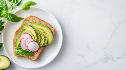 Fresh avocado toast topped with radishes and greens, perfect for a healthy breakfast or brunch option on a marble background.