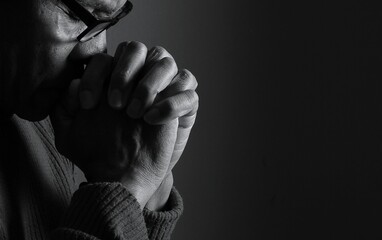praying to god with hands showing his religious faith with God Caribbean man praying with black background with people stock photo stock image