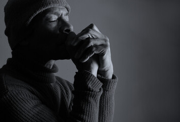 praying to god with hands showing his religious faith with God Caribbean man praying with black background with people stock photo stock image