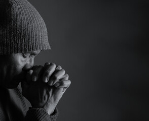 praying to god with hands showing his religious faith with God Caribbean man praying with black background with people stock photo stock image