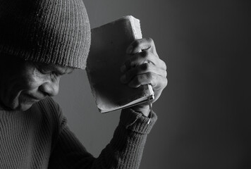 praying to god with hands showing his religious faith with God Caribbean man praying with black background with people stock photo stock image