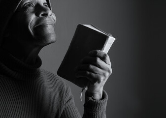 praying to god with hands showing his religious faith with God Caribbean man praying with black background with people stock photo stock image