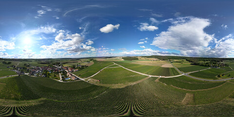 Trois-Puits, Reims, Marne, Grand-Est, France, August, 28th, 2025, Champagne Area, A breathtaking panoramic view displaying vibrant vineyards sprawling beneath a clear blue sky dotted with clouds