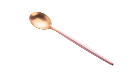 A shiny gold with an oval bowl and a long handle casting a shadow, angled on a surface, reflecting light on white and transparent