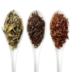 Spoons with diverse dried teas, displayed against black.