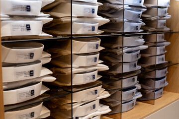Shelves for shirt and suit lovers. Choosing correct size of shirt for classic suit. Business person shopping in premium clothes store concept. Various of classic shirts on shelf