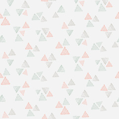 Hatch and crosshatch triangle groups of three, as minimalist mountains in colors of peach, green and gray on beige background. Abstract geometric seamless vector pattern. Great for home decor, fabric.