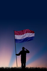 National flag of Netherlands flutters in military man hands