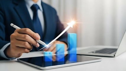 Businessman pointing at rising bar graph on digital tablet with laptop in background