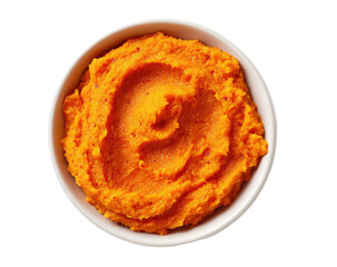 Bright orange mashed food swirls in a white bowl, presented against black