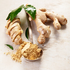 Fresh ginger with sliced and green leaves.