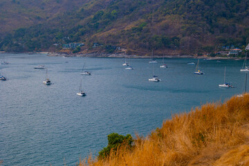Obraz premium Scenic view of cape promthep with boats in phuket, thailand