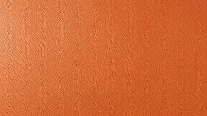Rich, textured orange leather surface providing a warm, vibrant backdrop