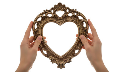 Hands holding an ornate gold heart shaped mirror isolated on transparent background