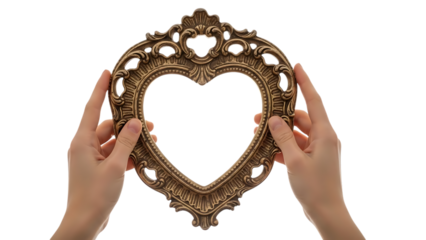 Hands holding an ornate gold heart shaped mirror isolated on transparent background