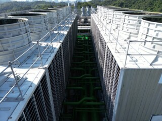 Fototapeta premium Aerial perspective view of cooling towers and green pipes for AI data center.