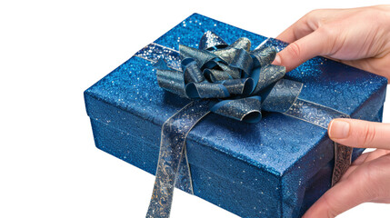 Hand holding a blue gift box with a shiny ribbon isolated on a white background