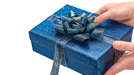 Hand holding a blue gift box with a shiny ribbon isolated on a white background