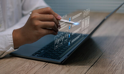 Business person holding pointing pen digital checklist interface on laptop symbolizing workflow management, productivity file document automation business process optimization technology modern office