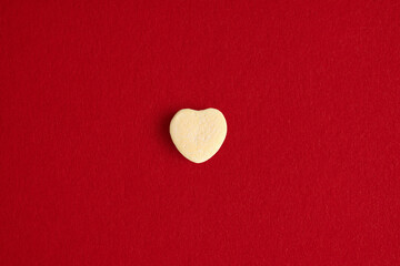 Single Candy Heart on Red Background Minimal Style