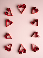 Symmetrical Paper Heart Pattern on Pink Background