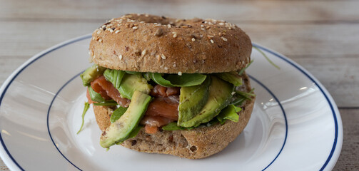 Bagel with smoked salmon, avocado, and fresh greens