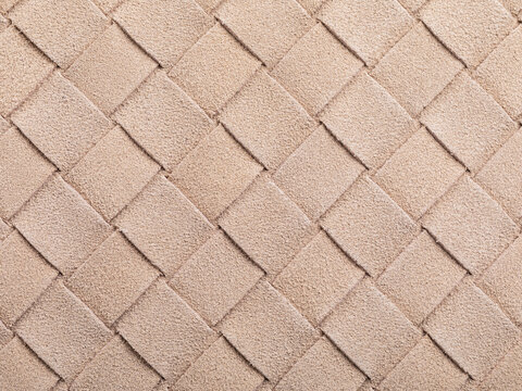 The beige texture of intertwined suede leather, forming a square abstract shape, authentic photograph, not AI-generated