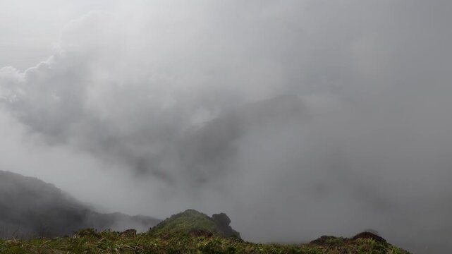 Clouds rolling over the rugged peak of Mt Guiting Guiting along the steep summit trail, G2 Sibuyan Philippines