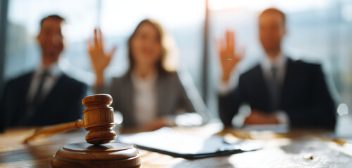 Legal consultation scene showing a female lawyer and her clients raising their right hands during a formal agreement or oath in a modern office setting