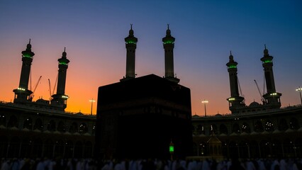 Holy Kaaba in Masjid Al-Haram, Mecca, Saudi Arabia during sunset with silhouette of minarets