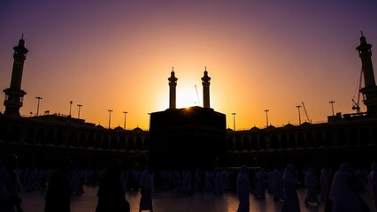 Holy Kaaba in Masjid Al-Haram, Mecca, Saudi Arabia during sunset with silhouette of minarets