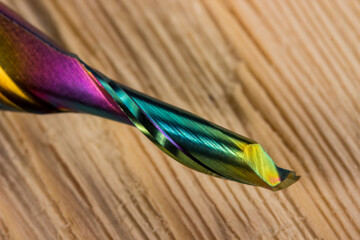 dlc milling cutter with carbide knives. carbon coating.  cutter for processing aluminum. close-up on a light wooden background. carbide milling cutter. knives for non-ferrous metals and duralumin.