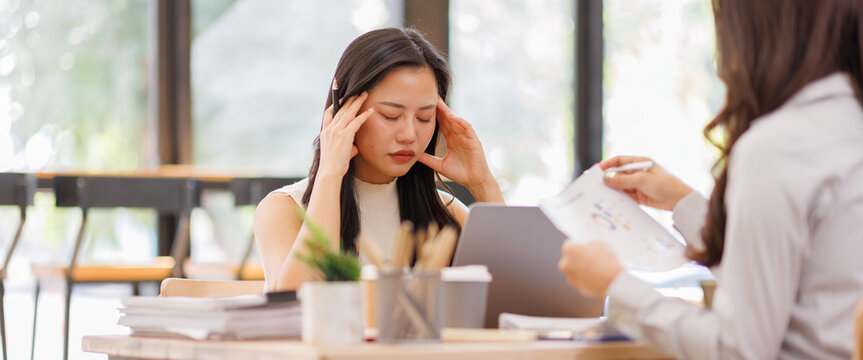 A tired Teamwork business women gets angry from the number of tasks, crumples up the paper and throws it away, tries to calm down by meditating. Stressful work and study, overtasking, headache.
