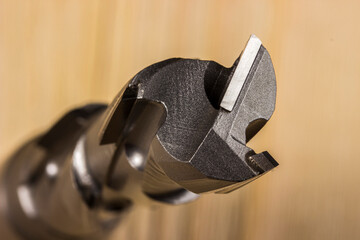 diamond woodworking cutter on a wooden background in close-up. carbide cutter. cnc tool.