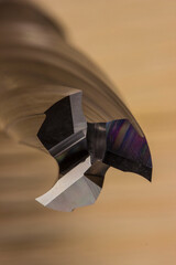wood processing cutter in close-up on a light wooden background. spiral carbide cutter.