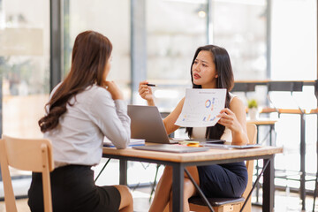 Fototapeta premium A tired Teamwork business women gets angry from the number of tasks, crumples up the paper and throws it away, tries to calm down by meditating. Stressful work and study, overtasking, headache. 