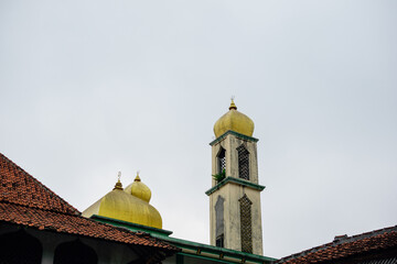 Islamic mosque architecture with golden domes and minaret tower