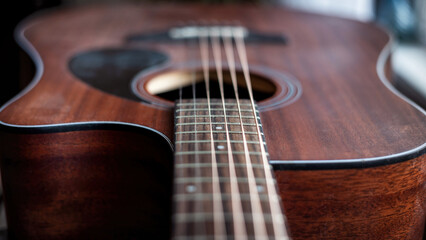 Strings and neck of an acoustic guitar.