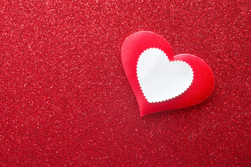 Vintage love concept featuring a clean white heart stamp label on a sparkling red texture. Design layout for wedding invitations or romantic love letters. Photo