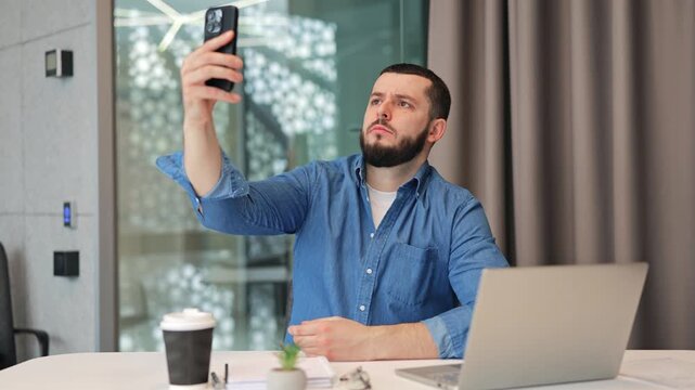 Upset business man in office experiences disappointment while trying to locate mobile network signal on smartphone. Connectivity issues cause frustration, hindering work.