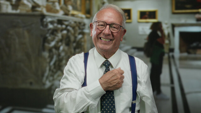 Senior man in suit laughing confidently at museum, showcasing vibrant indoor setting with art in background.